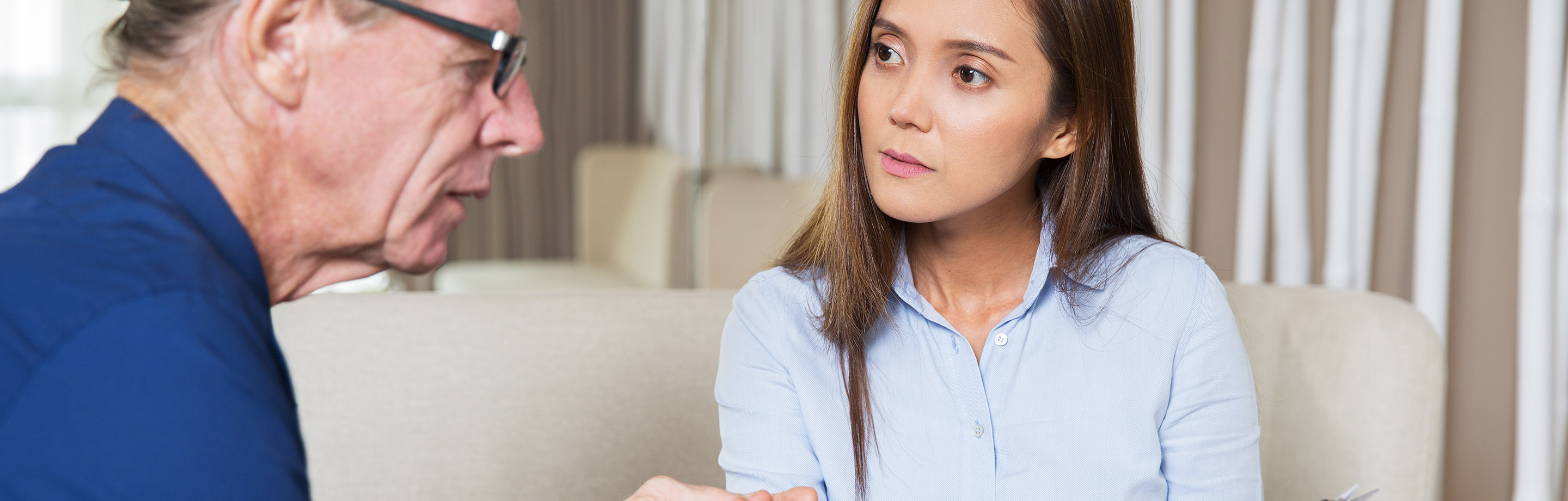 Daughter looks concerned as older father talks
