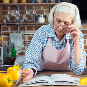 Older adult woman reading a recipe